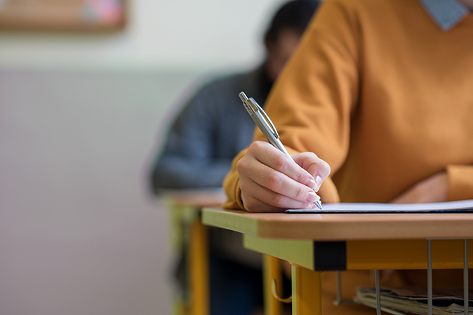 Woman sitting in class taking notes